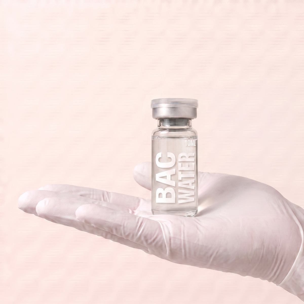 AURELIA bacteriostatic water 10ml vial held in a gloved hand, showing the vial size, for laboratory research use only