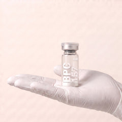 AURELIA BPC-157 10mg research peptide vial held in a gloved hand, showing the 3ml vial size, research use only