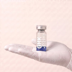 AURELIA GHK-Cu 100mg copper tripeptide research compound vial held in a gloved hand, showing the 3ml vial size, research use only