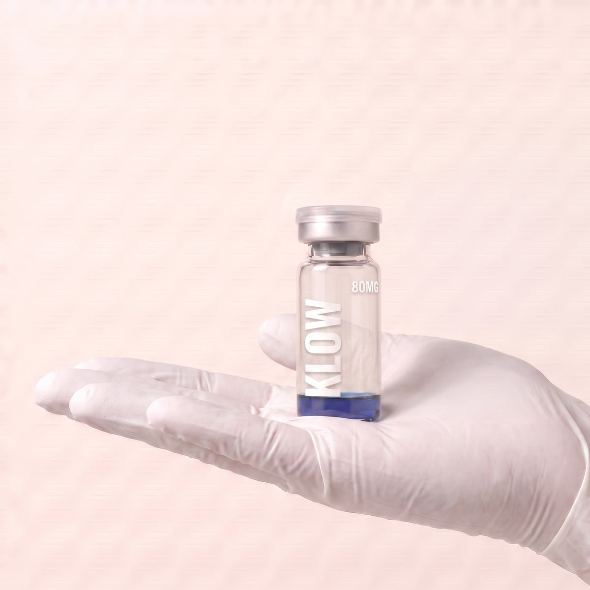 AURELIA KLOW 80mg multi-peptide research blend vial held in a gloved hand, showing the 3ml vial size, research use only